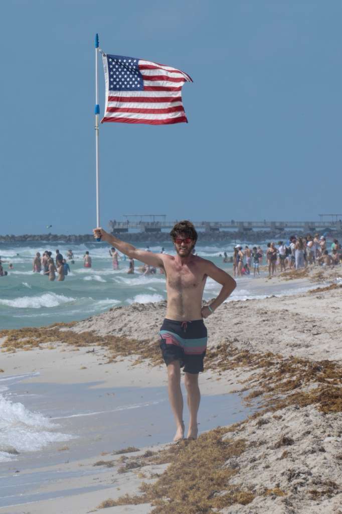 Glen Bradford standing with the American flag, Miami Beach Memorial Day 2026