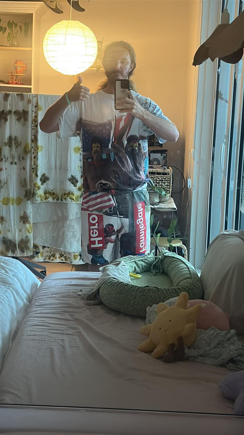 Glen Bradford wearing a Fanniegate Hero shirt, giving a thumbs up