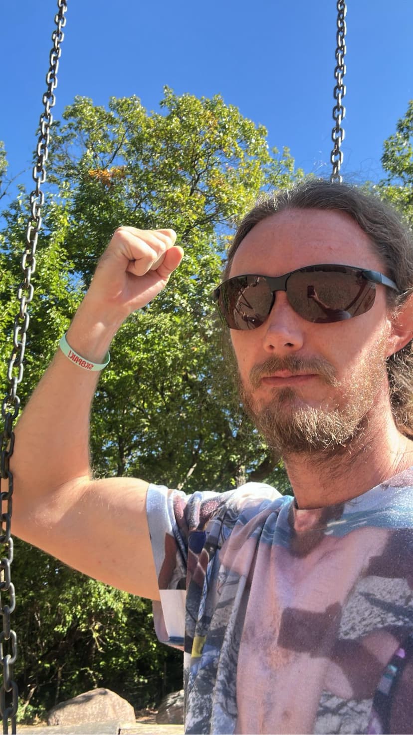 Glen Bradford outdoors fist pumping with sunglasses