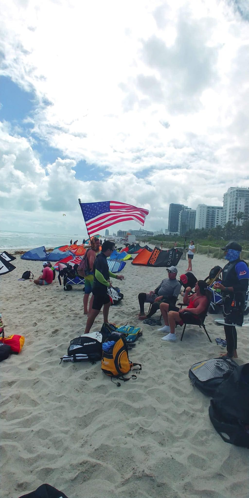Kite beach in Miami with American flag and kiters riding the wind